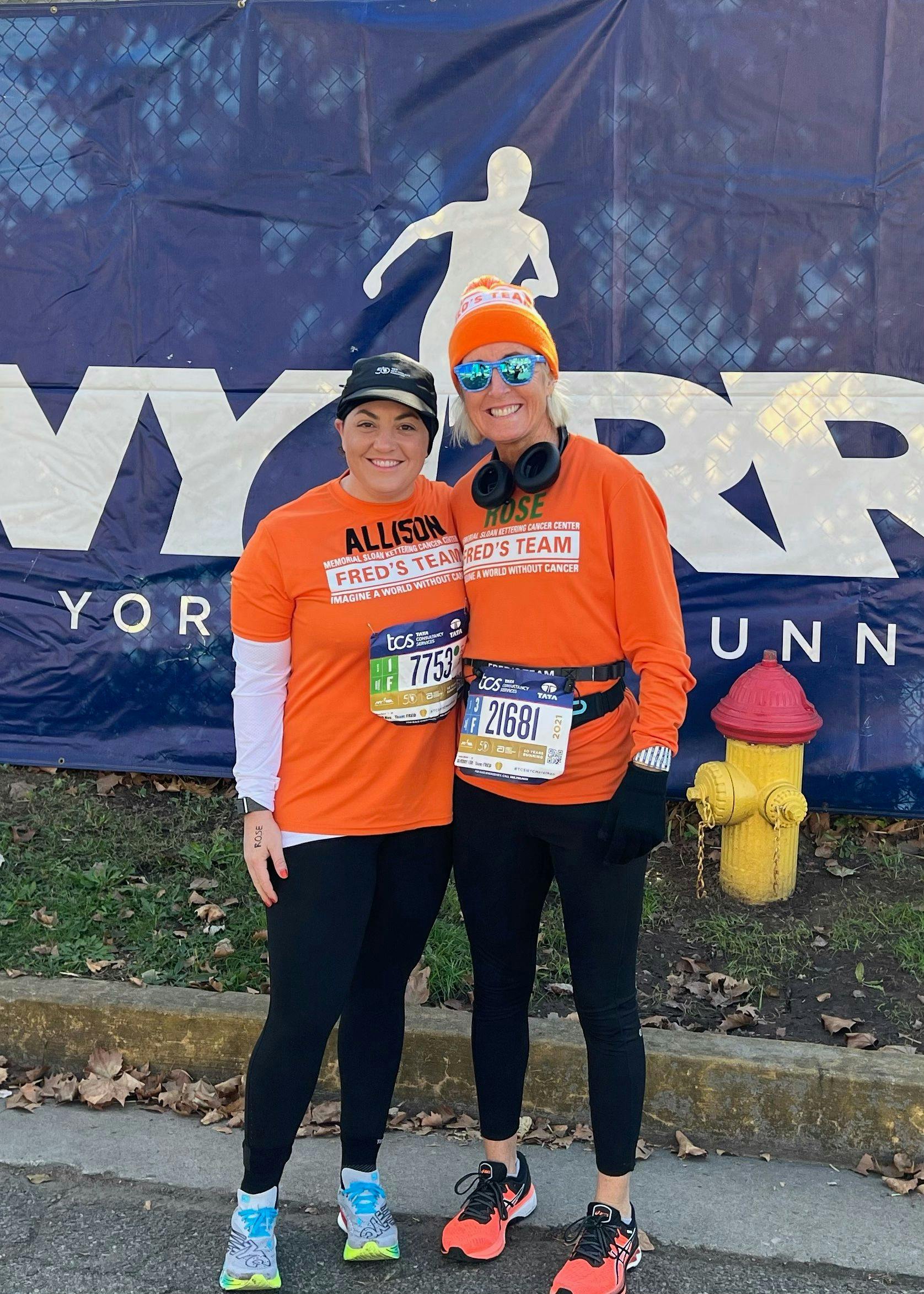 Dr. Allison Betof Warner and Rose Maxfield wearing orange shirts and running gear at the 2021 NYC Marathon