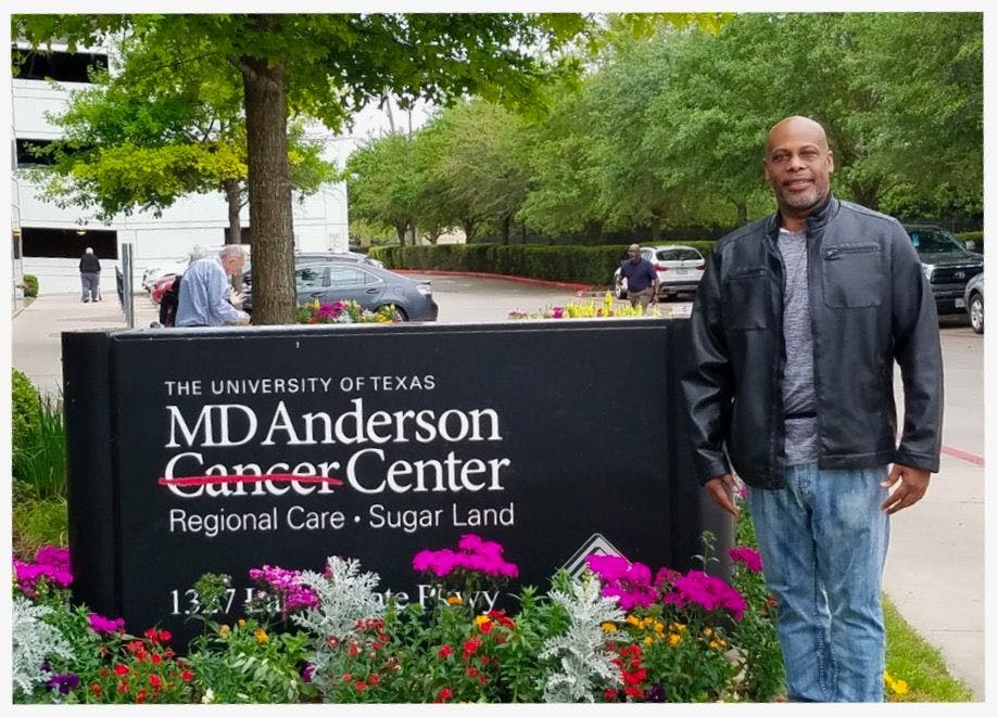 Drew Huggins stands by MD Anderson Cancer Center sign