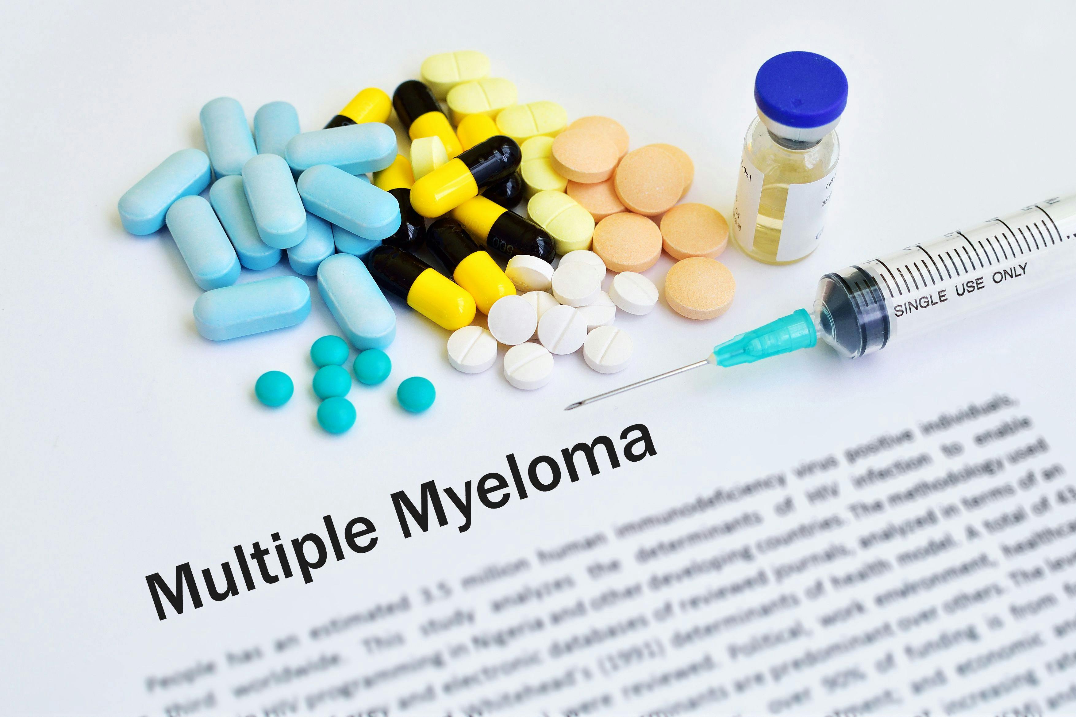 Image of pills and a vial with a syringe on a paper that says "Multiple Myeloma." 