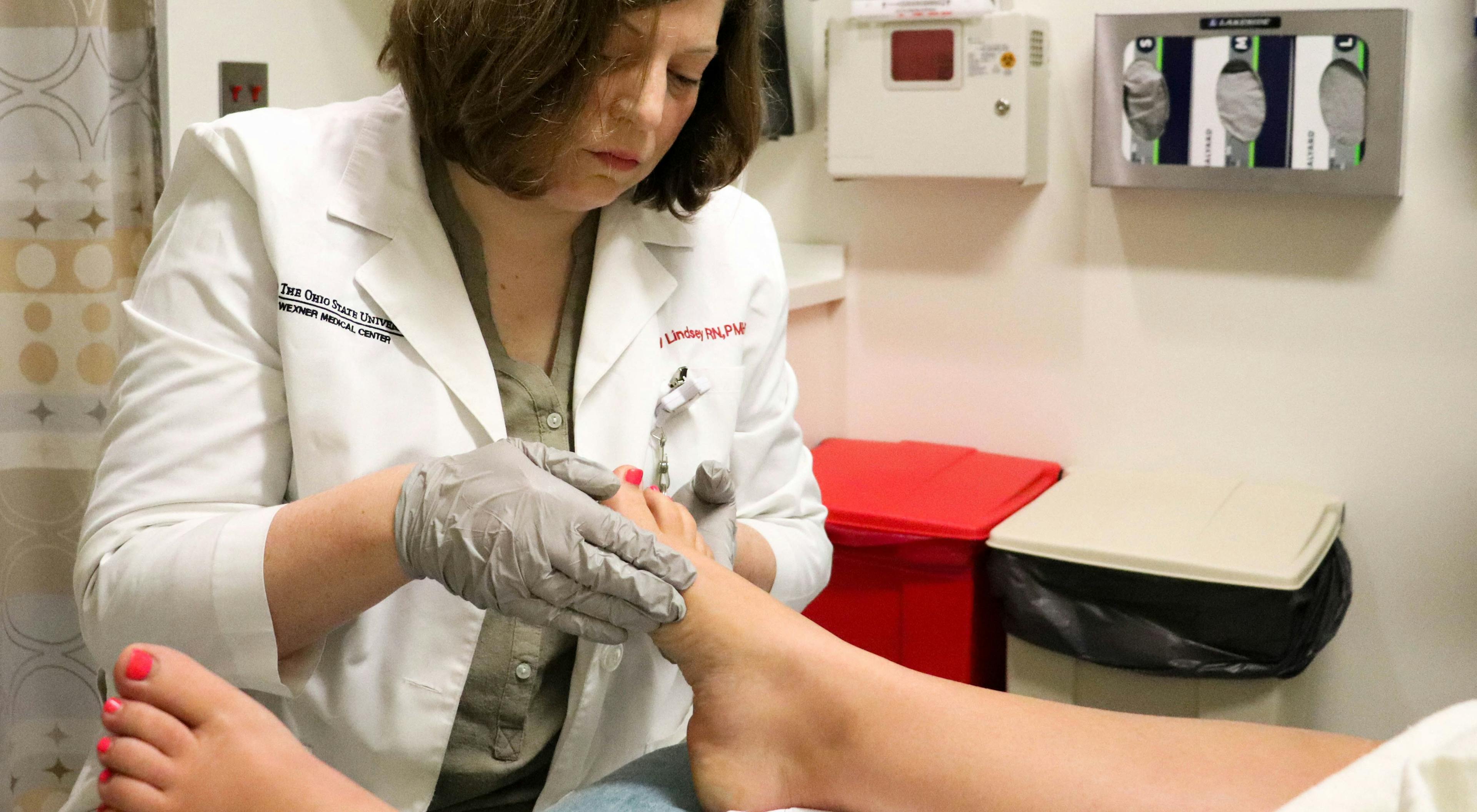 Amy Lindsey performs foot reflexology on a patient with cervical cancer. A new study at The Ohio State University Comprehensive Cancer Center - Arthur G. James Cancer Hospital and Richard J. Solove Research Institute found that, along with aromatherapy, reflexology reduced patients' use of pain medications by 40 percent during brachytherapy sessions.