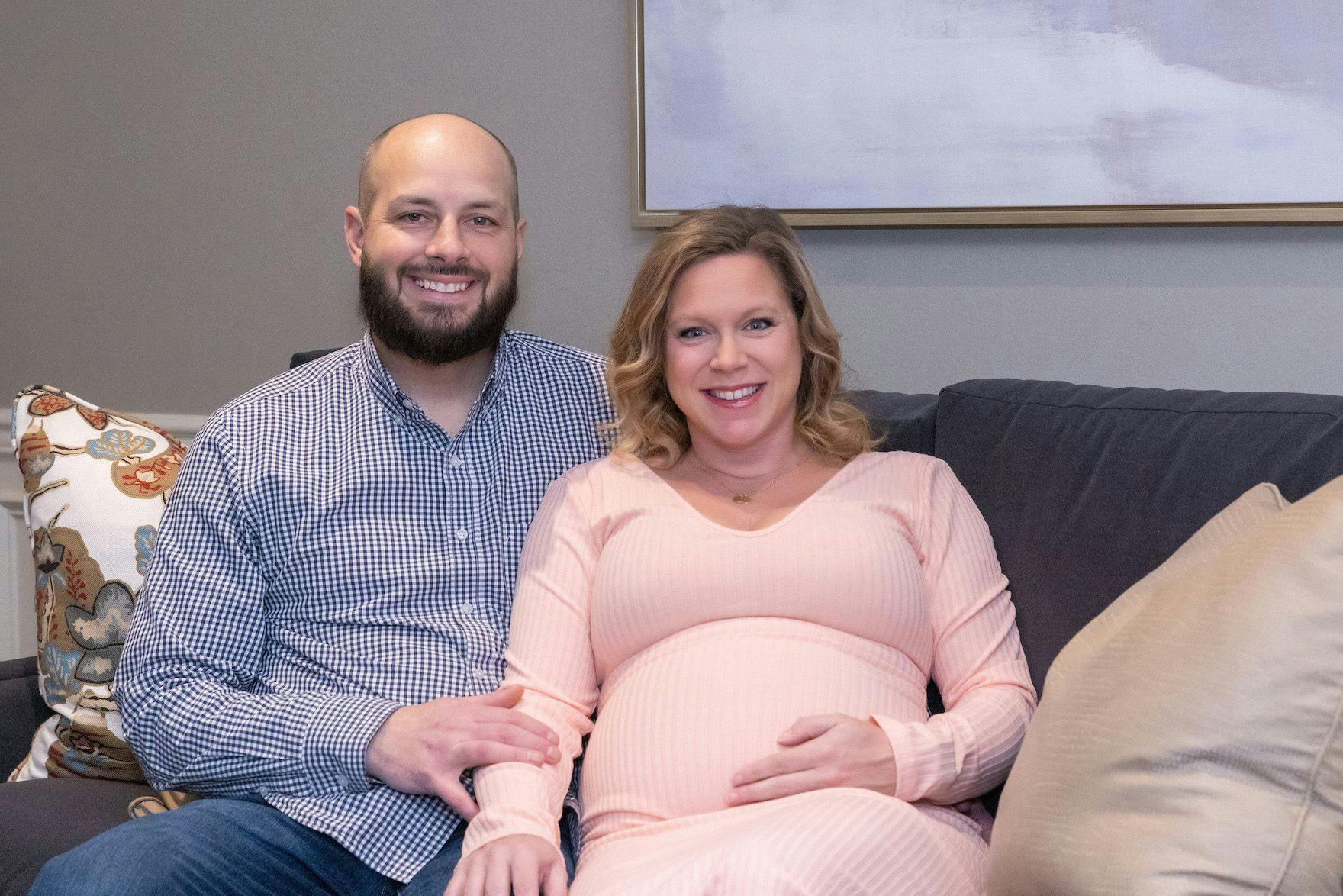 Lung cancer survivor, Daniel Wilson, sitting next to his pregnant wife. Both are smiling at the camera. | Image credit: Robert Barilla 