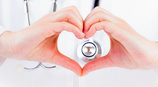nurse making heart symbol in front of stethoscope
