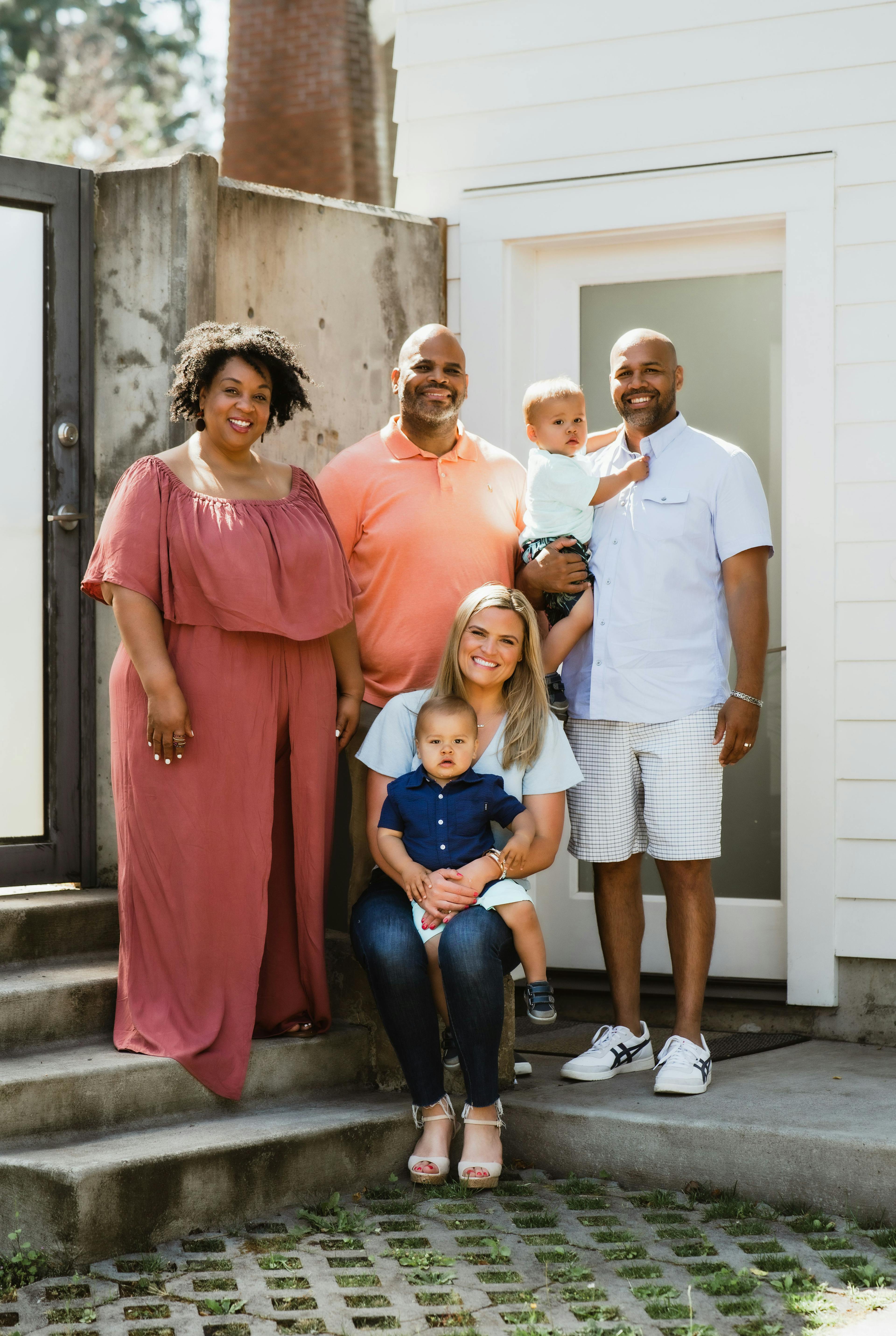 Tamika Felder (left) and her husband, Rocky Campbell (center), pose for a photo with Ginny Marable (sitting) and her partner (right) with the children of Marable and her partner, Sean. Recently, Marable offered fellow cervical cancer survivor Felder her unused embryos to start a family. Now, Felder and her husband are set to welcome a baby boy in November. 



Photo credit: Elyse Cosgrove from Torch Pictures