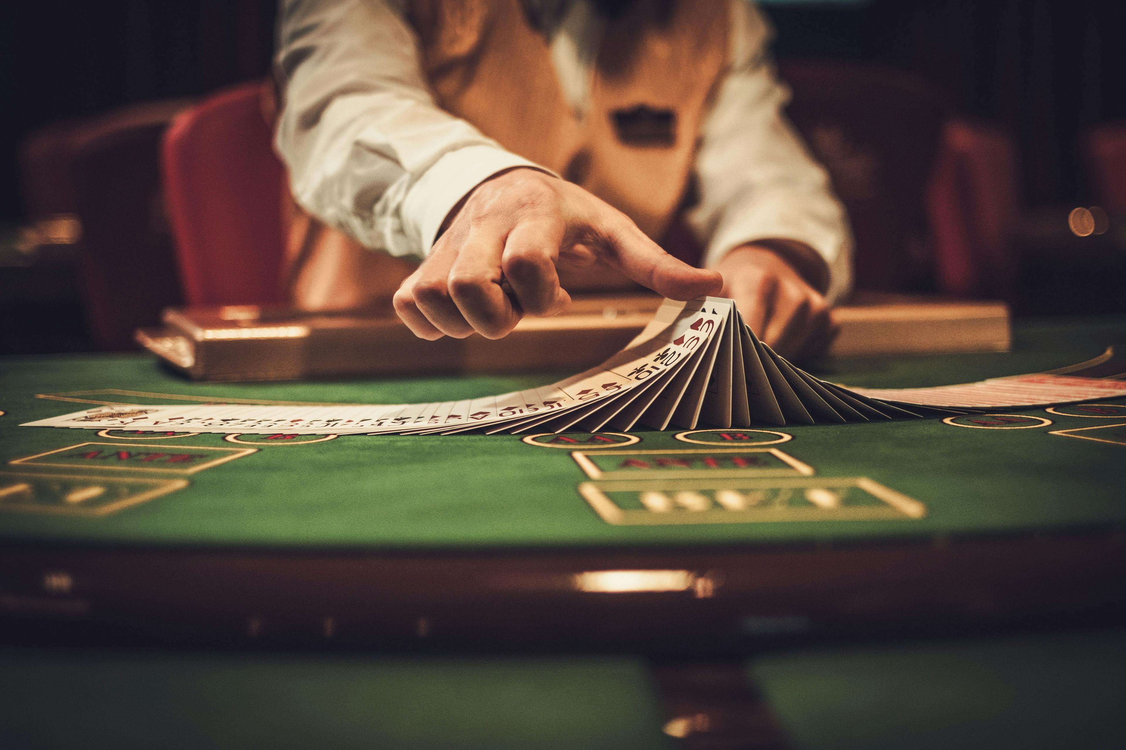 Croupier behind gambling table in a casino. credit: Nejron Photo stock.adobe.com