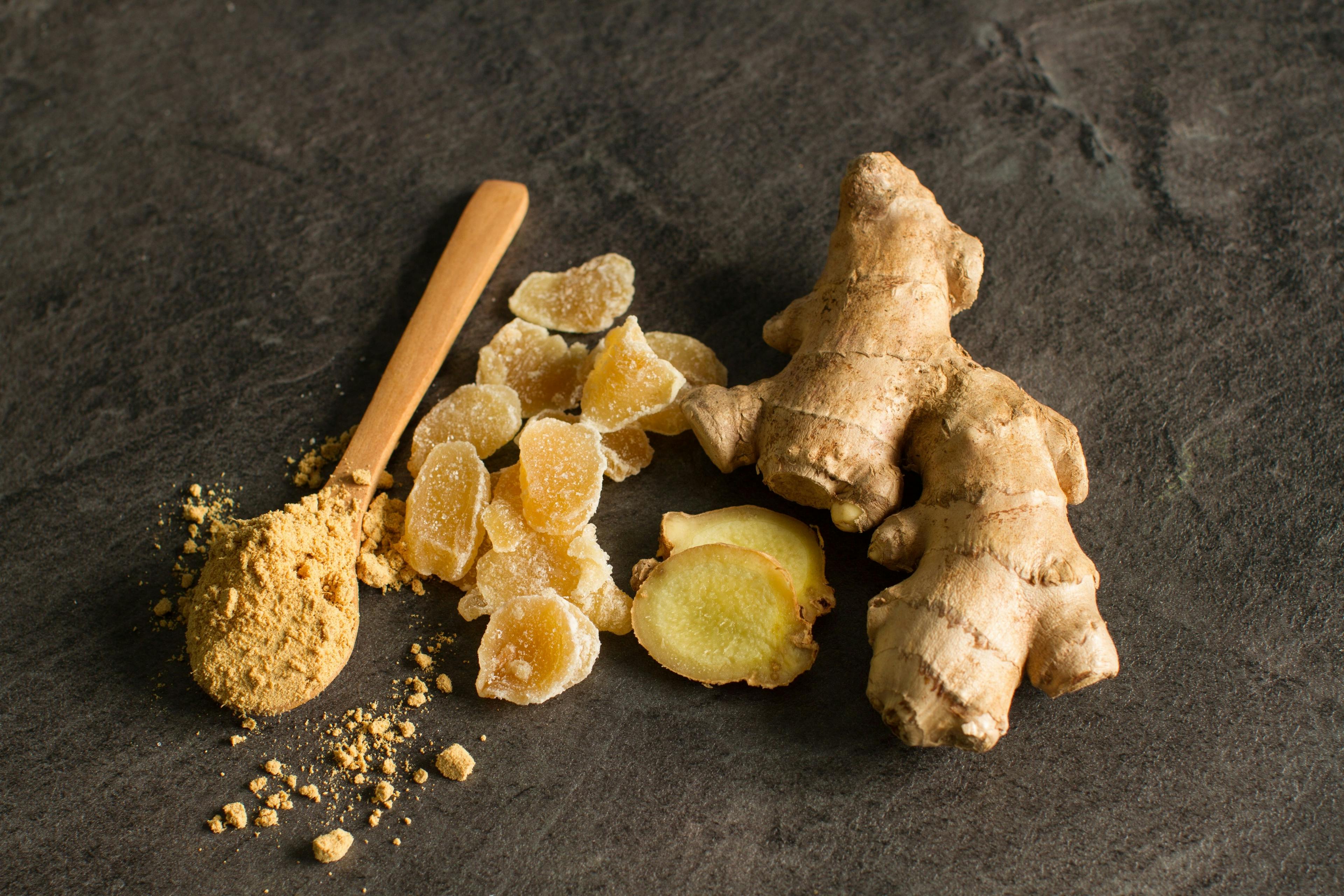 Ginger root, candied and ginger powder in wooden spoon over grey concrete background | Image credit: © DIA - © stock.adobe.com
