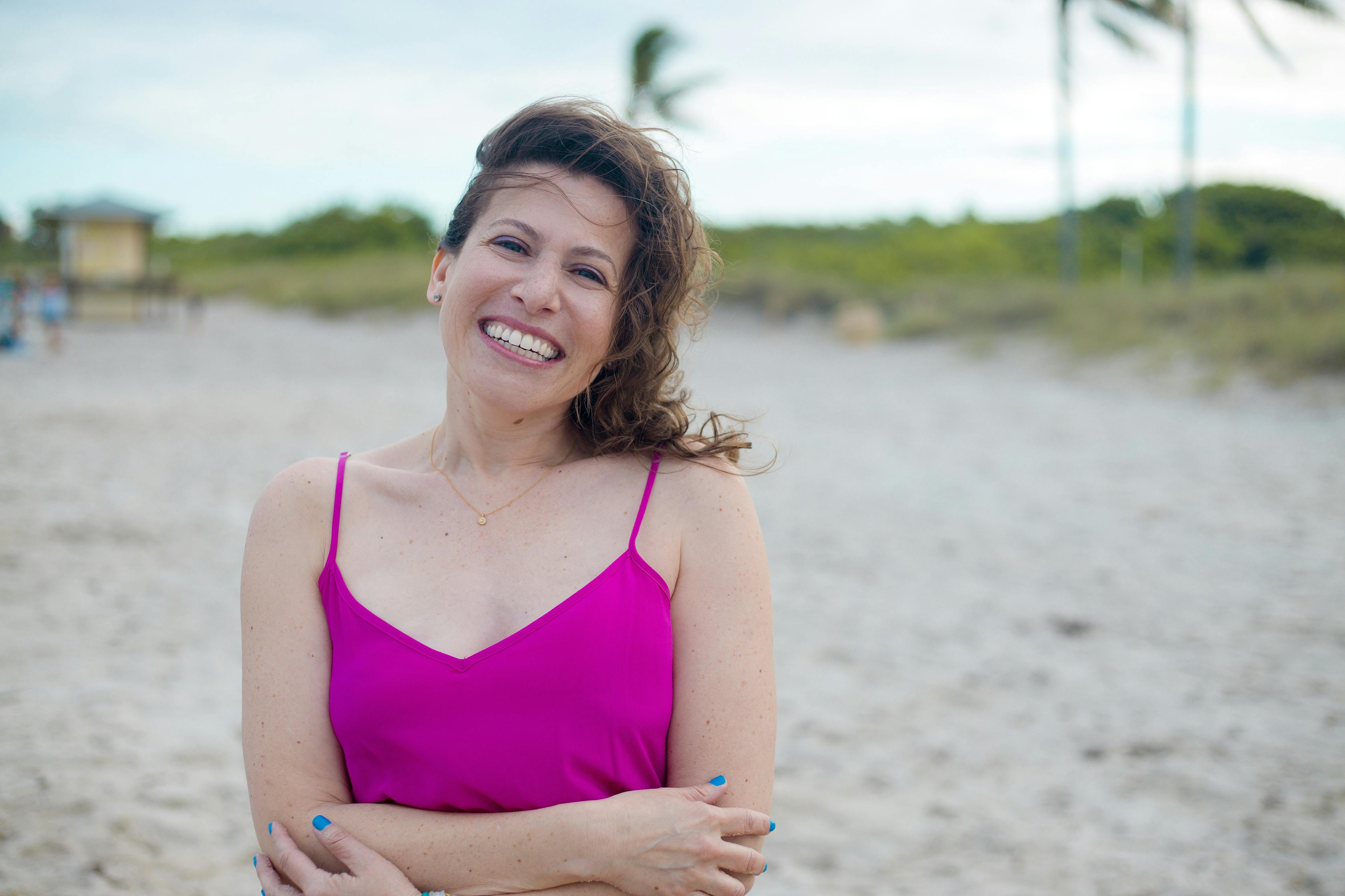 Cancer survivors, Sally Joy Wolf, smiling at the beach | Photo credit: Darcy Graf
