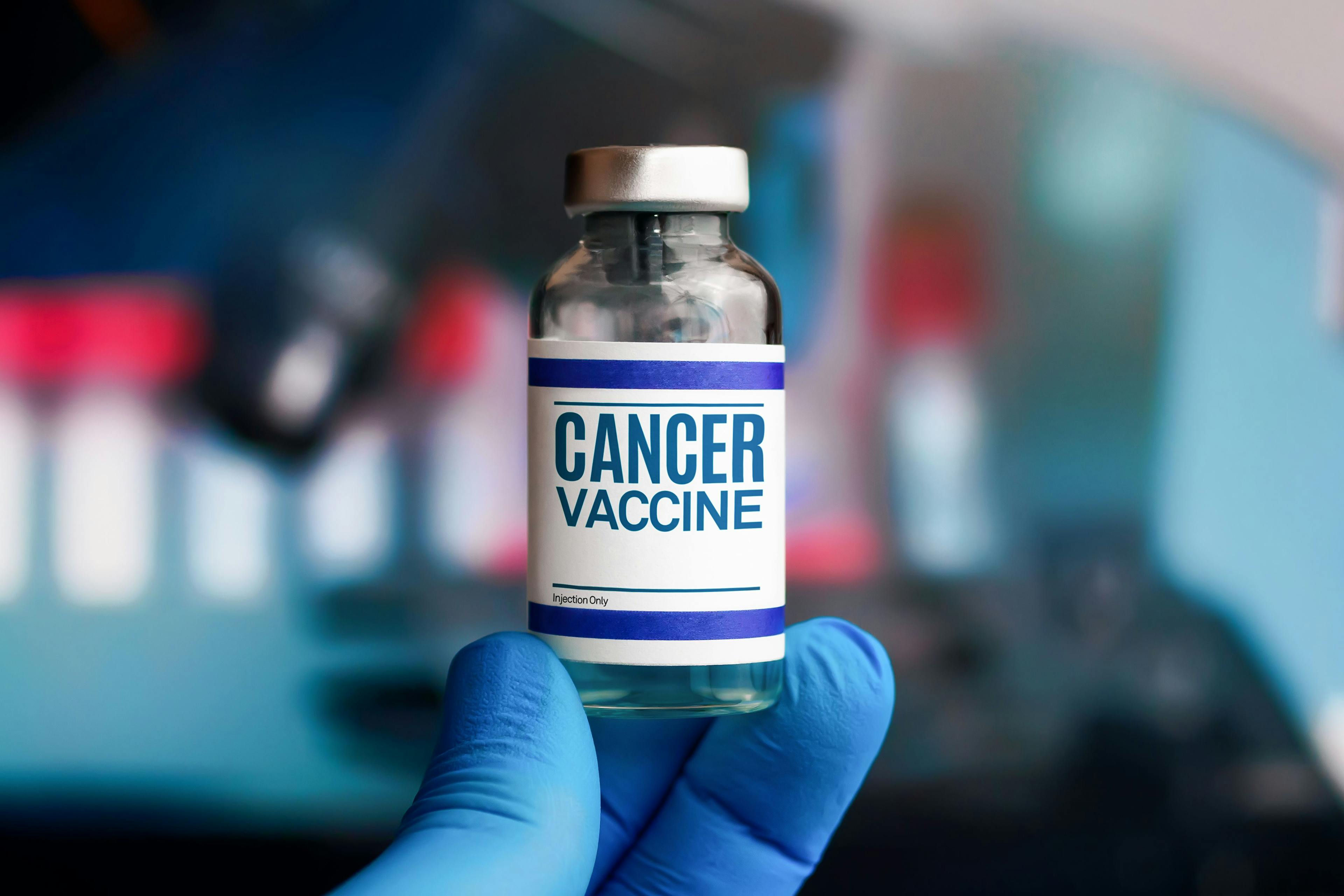 Image of a person holding a cancer vaccine vial.