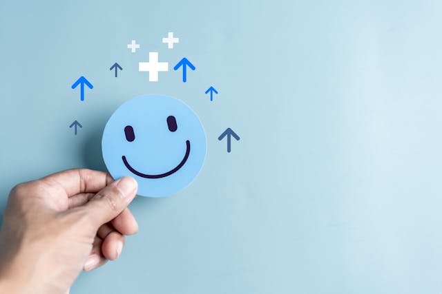 Hands holding blue happy smile face. mental health positive thinking and growth mindset, mental health care recovery to happiness emotion | Image credit: © - Kiattisak - © stock.adobe.com