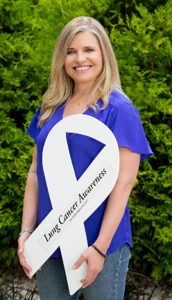 Heidi Nafman-Onda stands with the white ribbon her husband, Pierre, created that would eventually lead to Nafman-Onda developing The White Ribbon Project to increase awareness around lung cancer. 