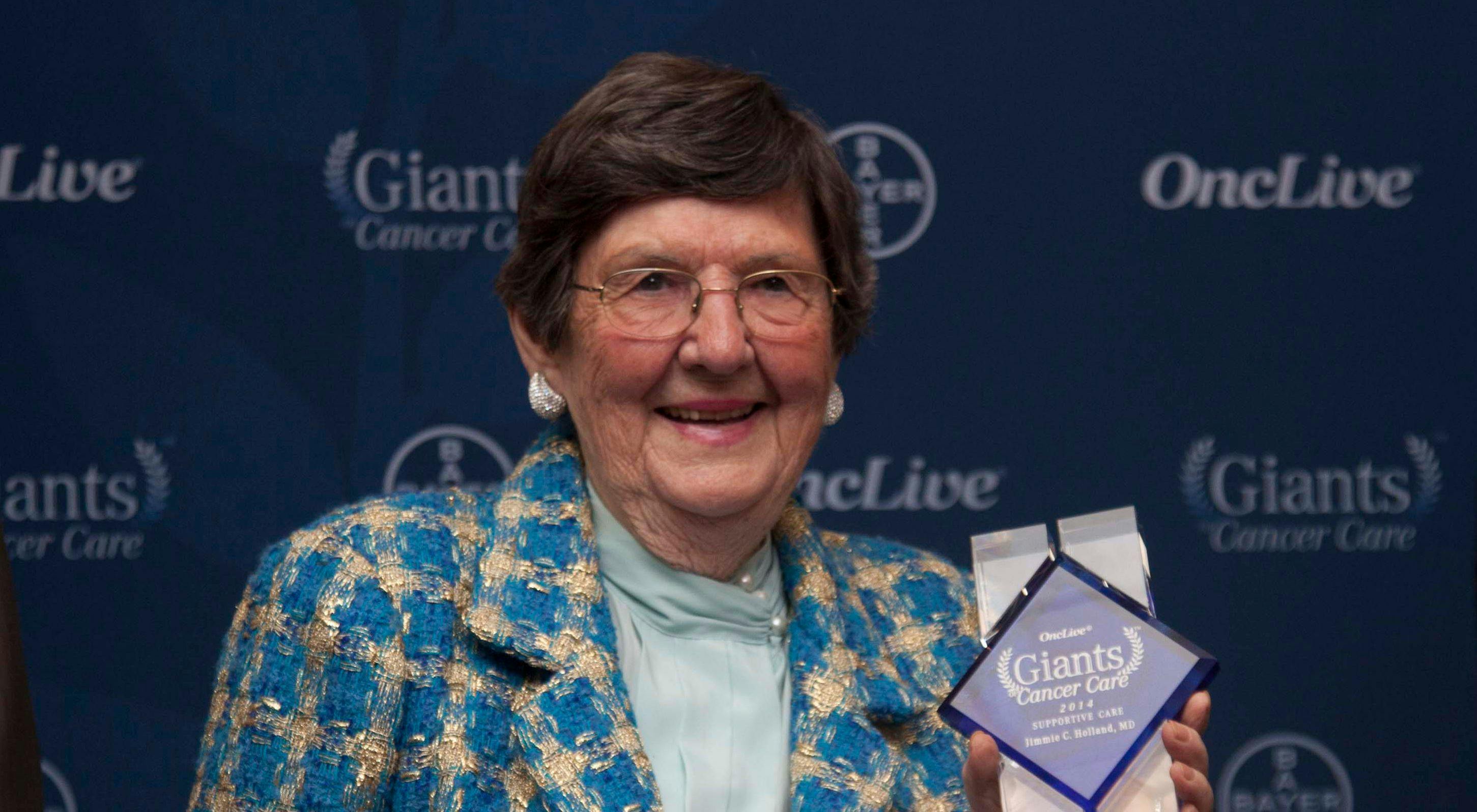 Holland receiving the Giants of Cancer Care award in 2014.