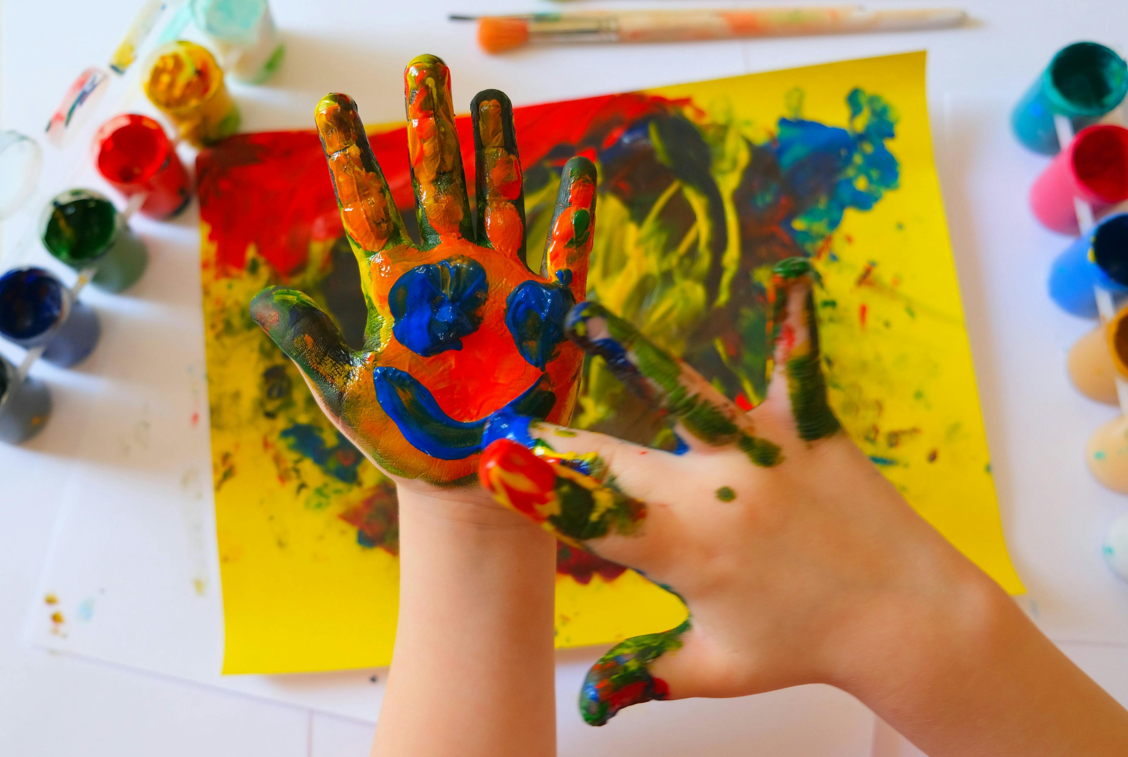 Art therapy for children with cancer: Child painting by finger hand. Ideas for drawing with finger paints. Children development . The concept of a happy childhood and children's day. | Image credit: ElenaEmiliya - stock.adobe.com