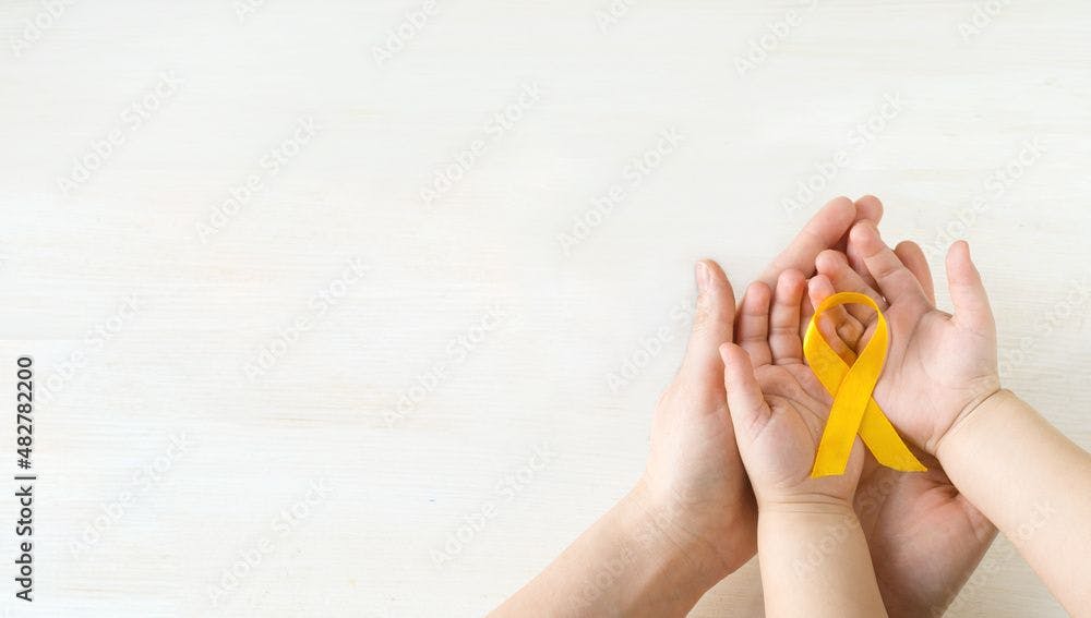 International Childhood Cancer Day. Mom and baby holding yellow ribbon in their hands. Sarcoma Awareness, bladder cancer. Leukemia cancer awareness. World Multiple Sclerosis day. I Am and I Will.  | Image credit: © - Ekaterina © - stock.adobe.com. 