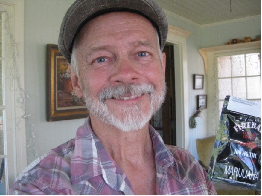 John Smelcer, PhD, CAGS, a non-Hodgkin lymphoma survivor, author with a package of cinnamon marijuana gummies. 