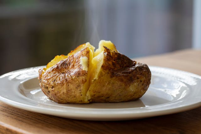 Hot baked potato with crispy skin and melted butter | Image credit: © Magdalena Bujak - © stock.adobe.co