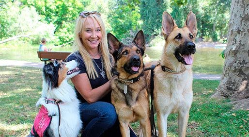 DINA ZAPHIRIS, founder
and CEO of the In Situ
Foundation — which trains
dogs to sniff out cancer
— poses with (from left)
Stewie, Linus and Leo.
Among them, the dogs have
the ability to detect breast,
lung, ovarian and
orolaryngeal cancers. - COURTESY DINA ZAPHIRIS