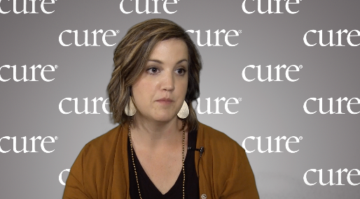 Kara Morris in an interview with a gray "CURE" background