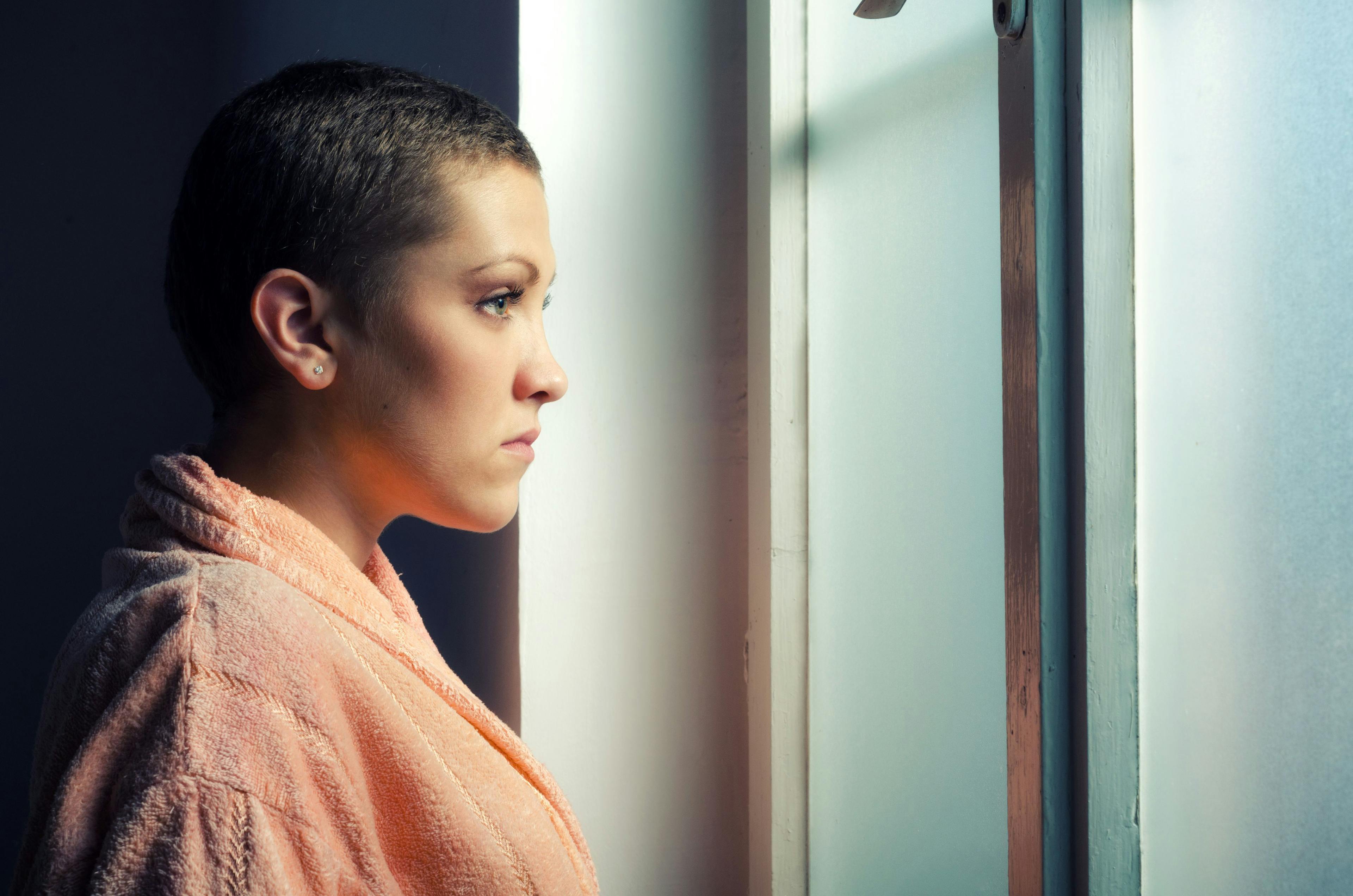 female patient with cancer looking out window