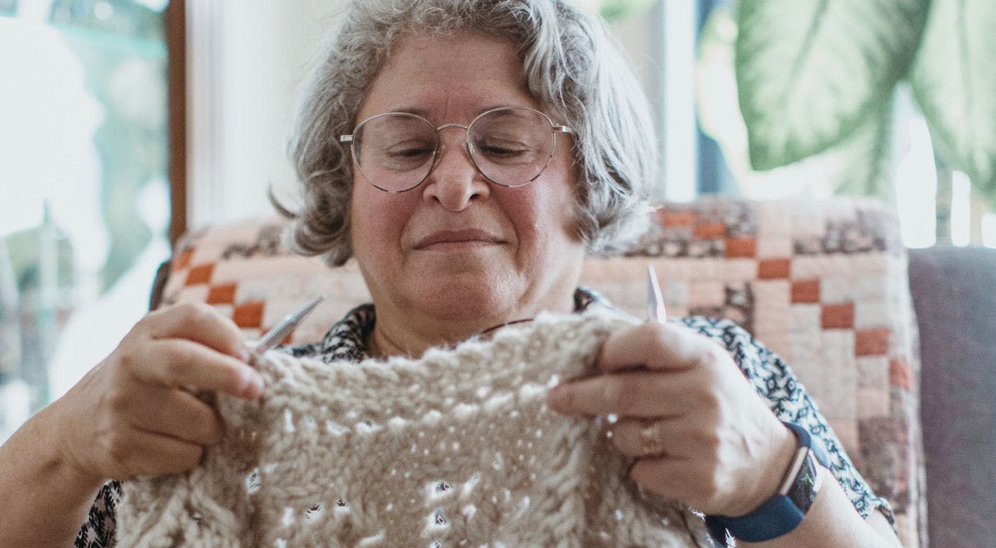 SYLVIA MORITZ finds that knitting helps
control arthralgia in her hands. - PHOTO BY MARIA DEFORREST
