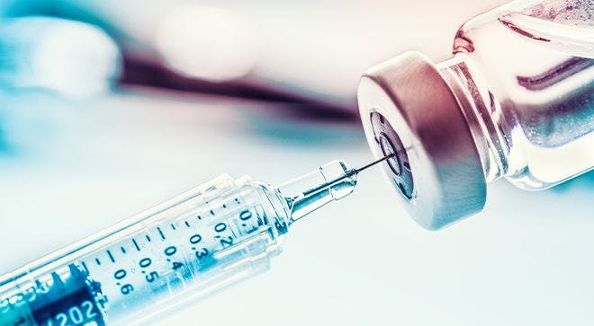 Image of a vaccine needle in a vial.