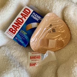 band-aid and prosthetic breast