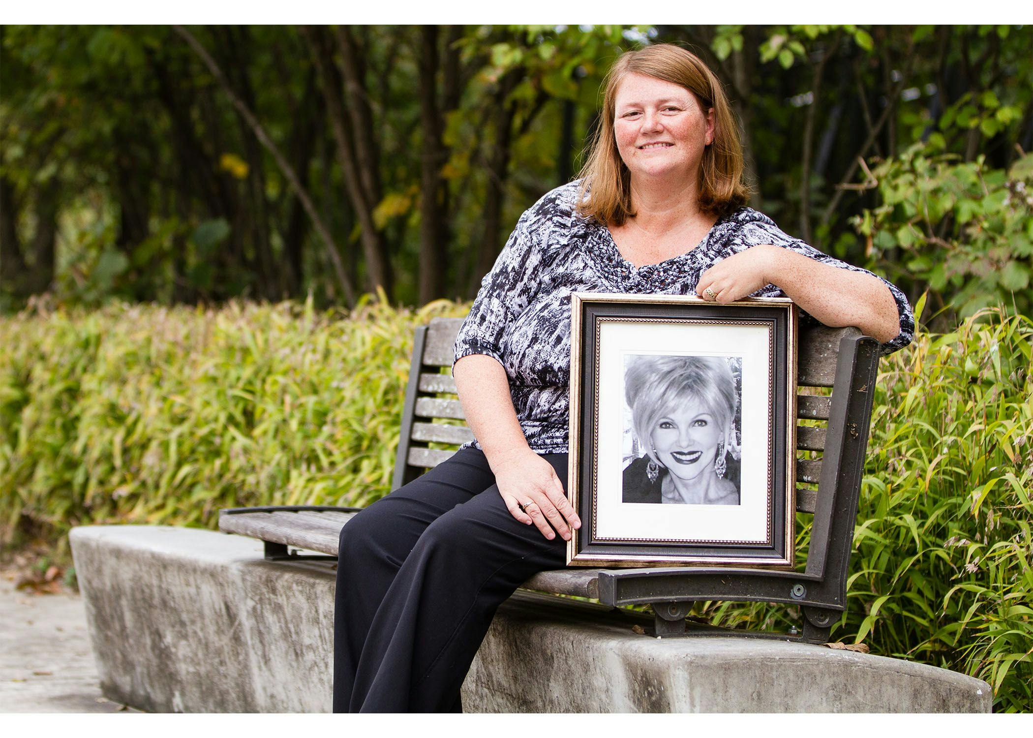 Alison Moore, RN, BSN, OCN, holding a photo of Helen Lee - PHOTO BY SERGIO PLECAS