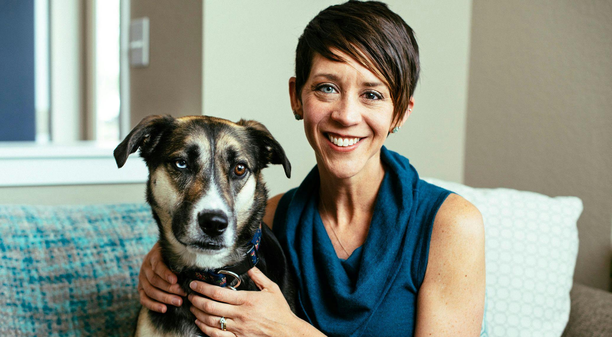 KATIE DOBLE and
her dog, ALICE, have
matching eyes. Doble's
dark brown eye color
changed to blue after
a series of procedures
related to her cancer. - PHOTO BY RYAN DEARTH