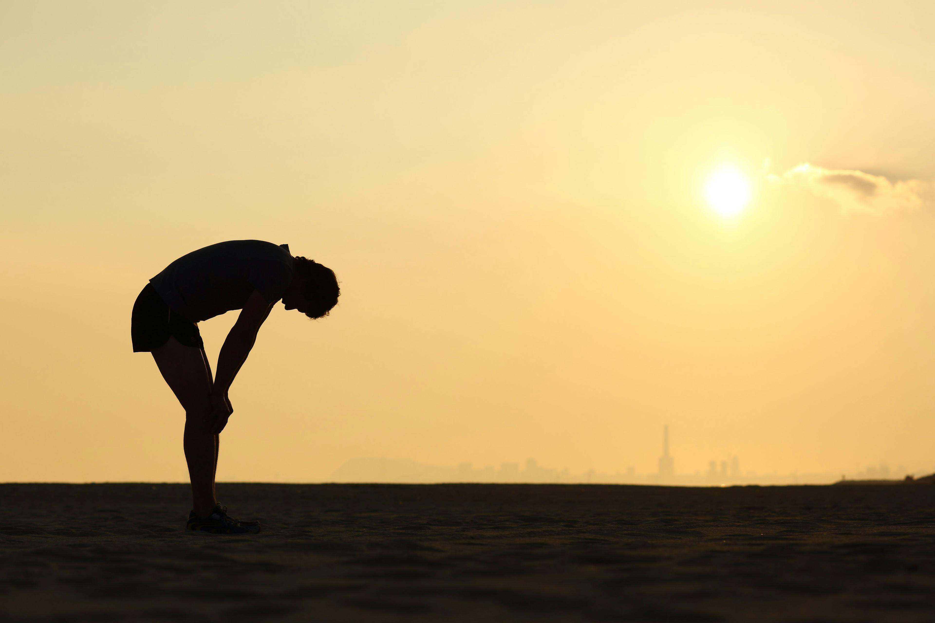 Silhouette of an exhausted sportsman at sunset | Image credit: © Antonioguillem - © stock.adobe.com