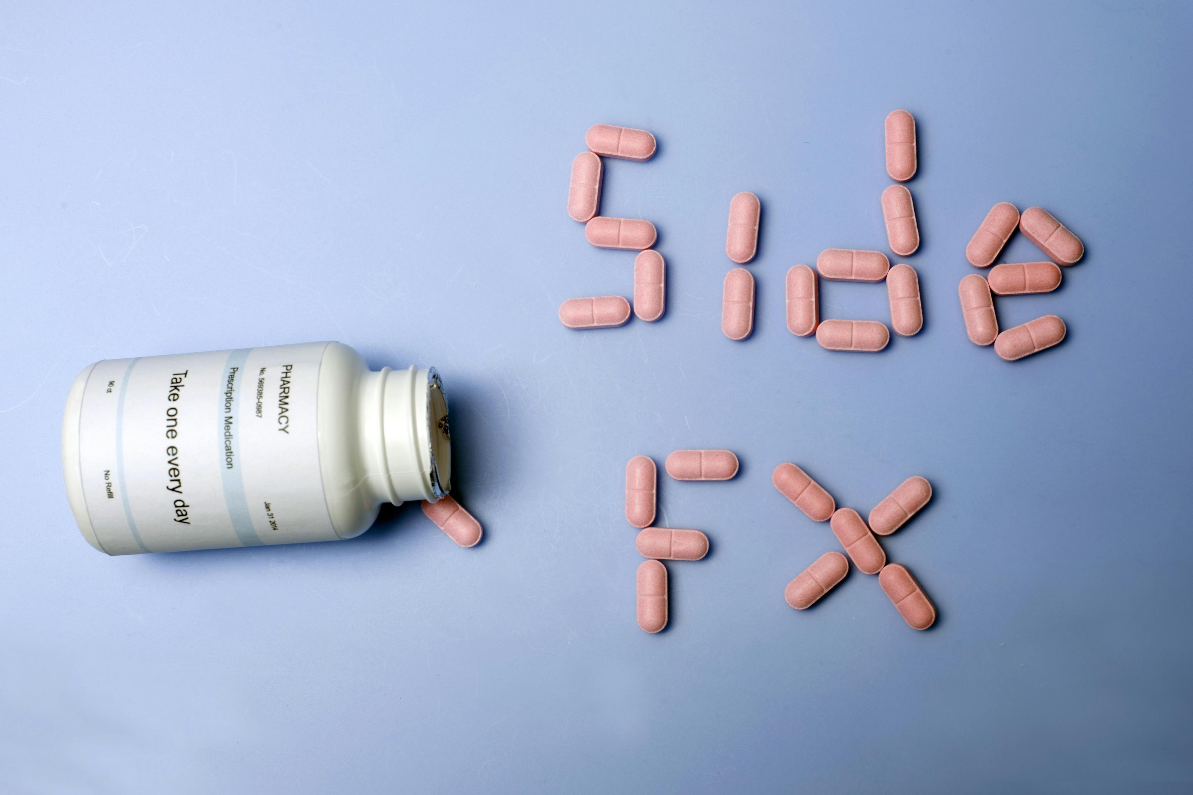 a bottle spilling out pills that say "side FX"
