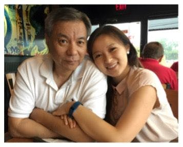Lin Qiao with his daughter, Sabrina, next to him wrapping her arm around his and putting her head on his shoulder