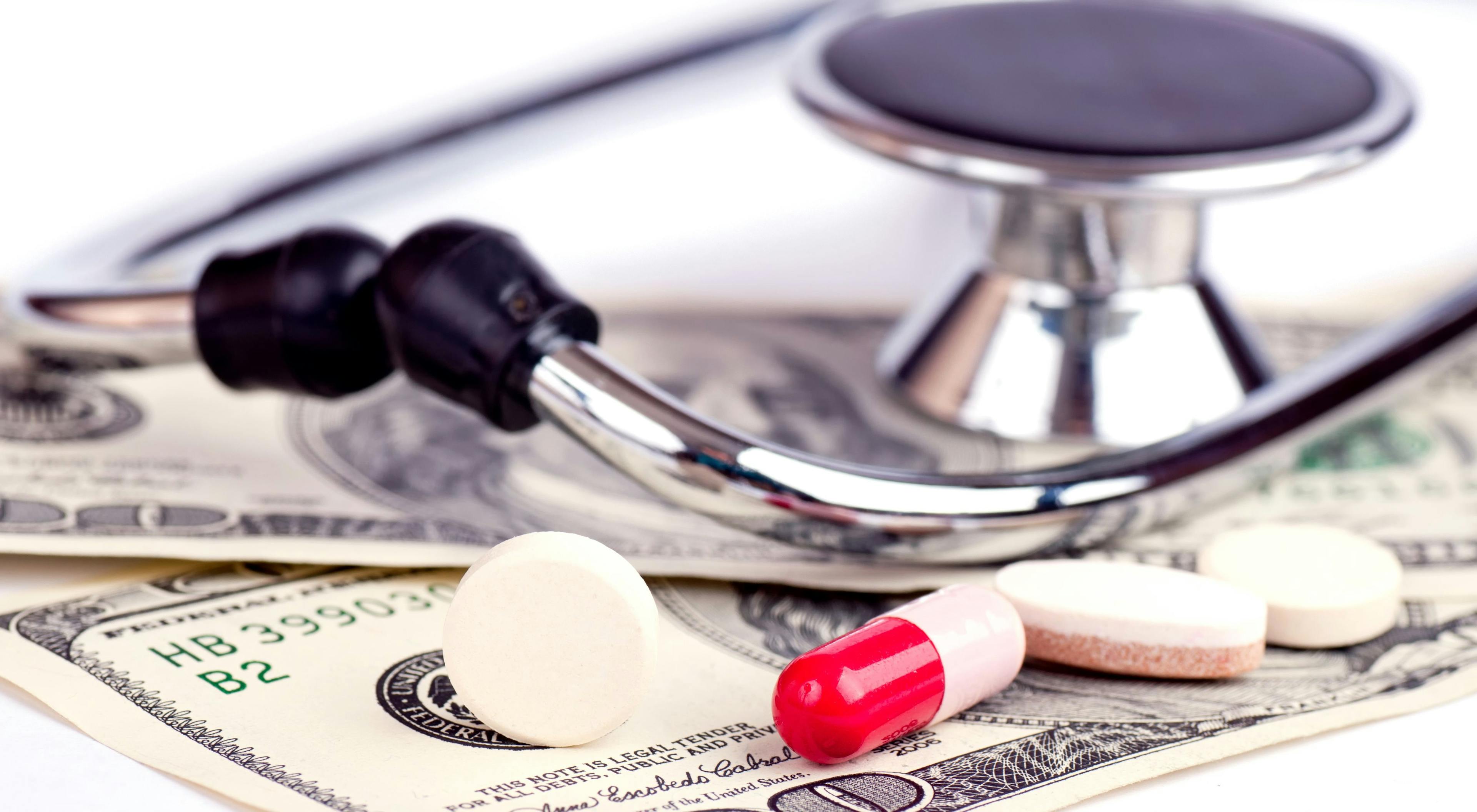 image of stethoscope and pills on top of dollar bills